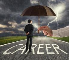 Businessman ready to start a difficult career way with a big help of an umbrella. concept of support and assistance photo
