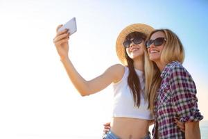 Happy group of friend makes a selfie with a mobile phone. photo