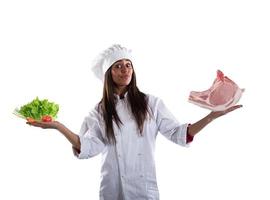 Chef undecided between fresh salad or meat steak. concept of vegetarian photo