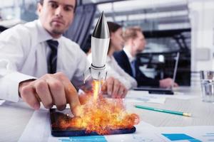 Businessperson in office work for a startup of a company with a rocket photo