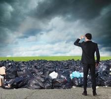 Businessman searches far for clean environment. overcome the global pollution problem photo