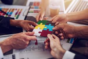 Teamwork of partners. Concept of integration and startup with puzzle pieces photo