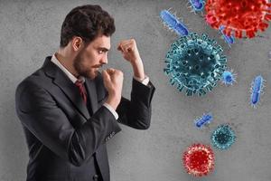 Businessman fights like a boxer. Concept of viruses and bacteria attack photo