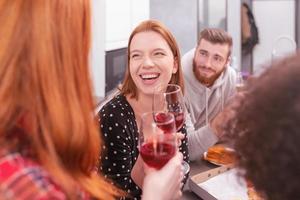 Festive party among multi-ethnic friends at home photo