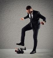 Furious businessman who want to trample his employee photo