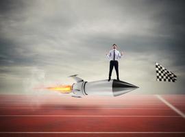 Winner businessman over a fast rocket. Concept of business competition photo