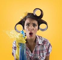 Girl housewife with gloves and spray ready to clean photo