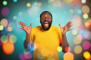Man is surprised and excited about Christmas. cyan background photo