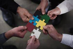 Teamwork of partners. Concept of integration and startup with puzzle pieces photo