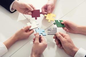 Teamwork of partners. Concept of integration and startup with puzzle pieces photo