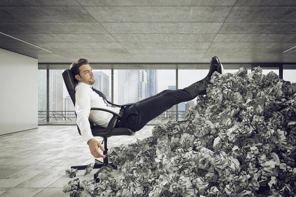 Businessman with paper sheet anywhere. Buried by bureaucracy. Concept of overwork