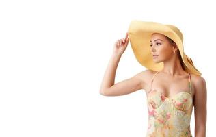 Girl with hat at the beach with a bright sea photo