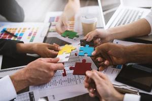 Teamwork of partners. Concept of integration and startup with puzzle pieces photo