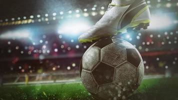 Close up of a soccer striker ready to kicks the ball at the stadium photo