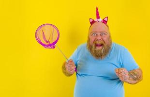 Fat happy man with headband play with sea net photo