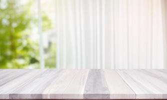wooden table top on blurred background of half curtained window photo