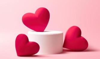 red 3d hearts on a pink background photo