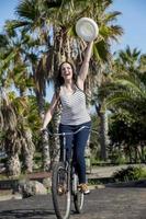 Cheerful female cycling on holiday in Spain photo