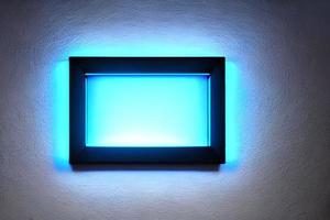 Bright blue rectangle neon frame at the wall backdrop and background. photo