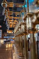 close-up of golden beer pump inside a brewery photo