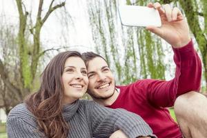 nice couple boyfriends takes a selfie relaxing  on deckchair outdoor photo