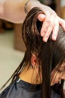 Young woman receiving treatment her hair photo