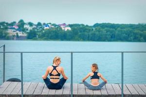 Mother and daughter doing gym exercises photo