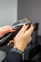 Hair clipper in hands of female photo