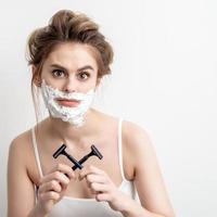 Woman with shaving foam on her face photo