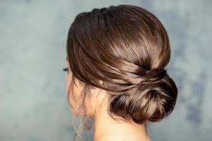 Brunette woman with middle bun hairstyle photo