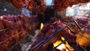 Close up 5 rows of grilled chicken rotate burn by charcoal fire video