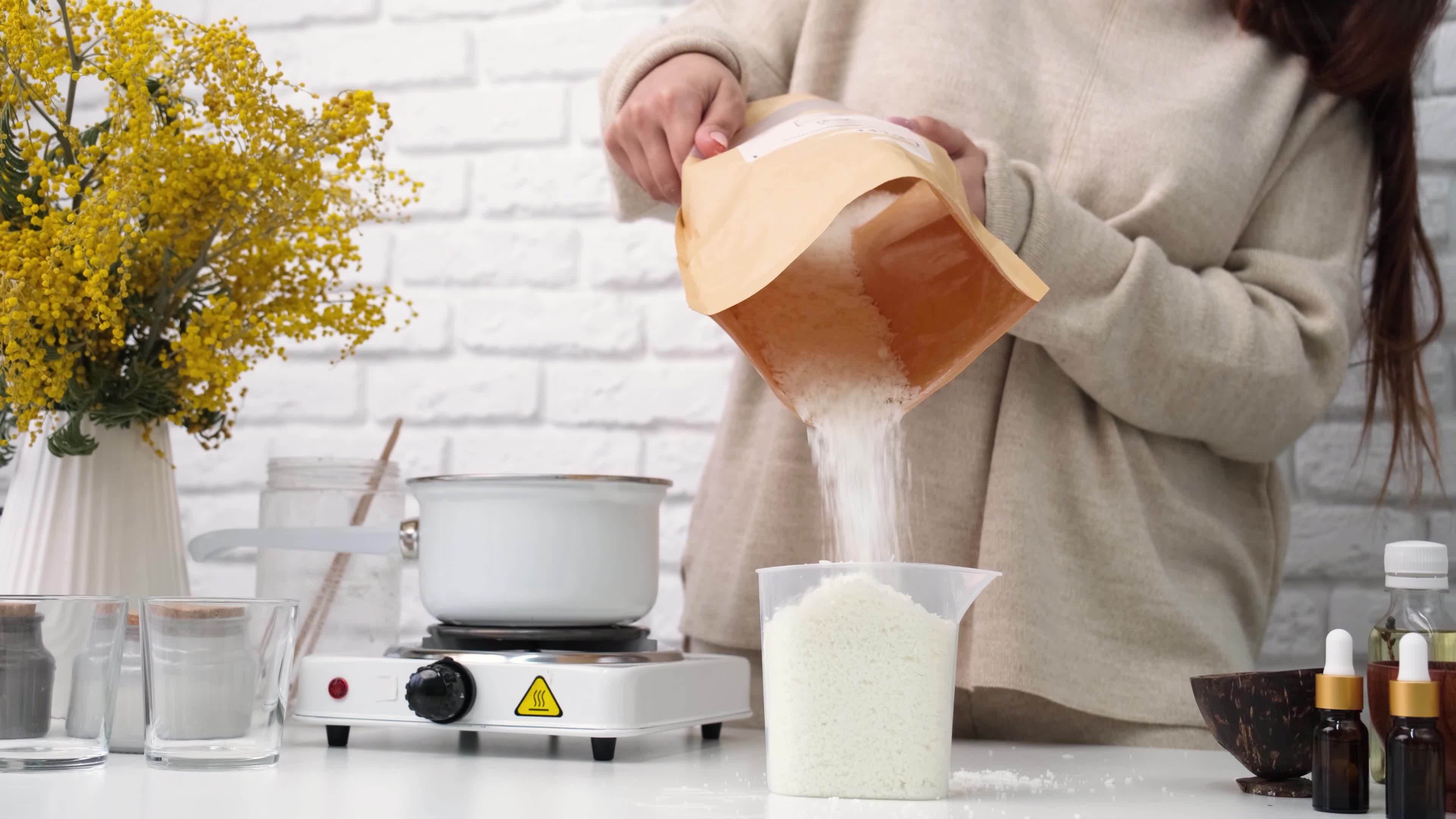woman making candles, melting soy wax in the pot 20578280 Stock Video