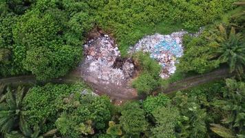 Aerial descending garbage dump at green lush outdoor video