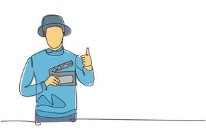 Single continuous line drawing the film director with a thumbs-up gesture while holding the clapperboard set the crew for studio shooting. Dynamic one line draw graphic design vector illustration.