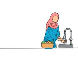 Single one line drawing of a woman in a hijab was washing the fruit in the sink from the germs that stick to it clean. Fruit put in a pretty basket. One line draw design graphic vector illustration.