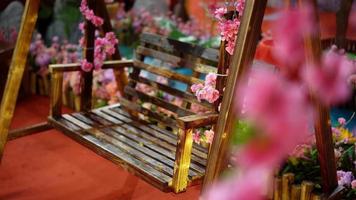 Wooden swing chair with decoration of fake plum video