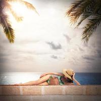Girl in bikini sunbathes photo