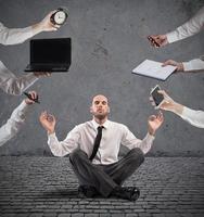 Relaxed businessman that does yoga during the work photo