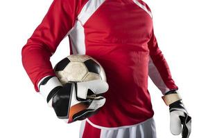 Goalkeeper holds the ball in the stadium during a football game. Isolated on white background photo