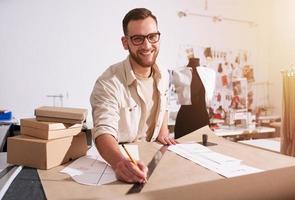 Seamstress works to new clothes ordered by internet client photo