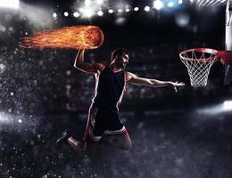 Basket player throws the fireball at the stadium photo