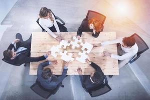 Teamwork of partners. Concept of integration and startup with puzzle pieces. double exposure photo