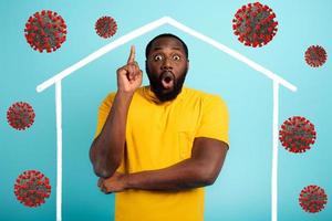Concept of stay at home message with a man inside his house and around outside covid 19 coronavirus photo