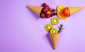 Ice cream with natural fruits. Concept of genuine and biologic fruit. Purple background photo