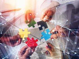 Business team connect pieces of puzzles. Teamwork, partnership and integration concept. double exposure with network effects photo