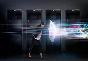 Concept of safety in a data center room with database server. Woman with shield defends against hacker attacks photo