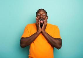 Amazed and shocked expression of a boy over cyan background photo
