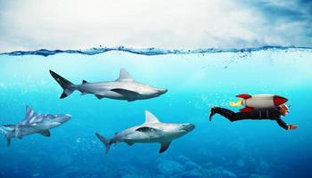 Concept of competition. Businessman escapes from sharks with a rocket photo