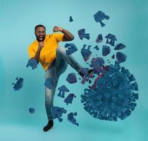 Man attacks with a kick the coronavirus. Blue background photo