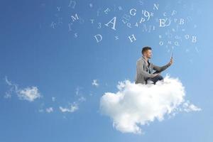 Businessman works over a cloud photo